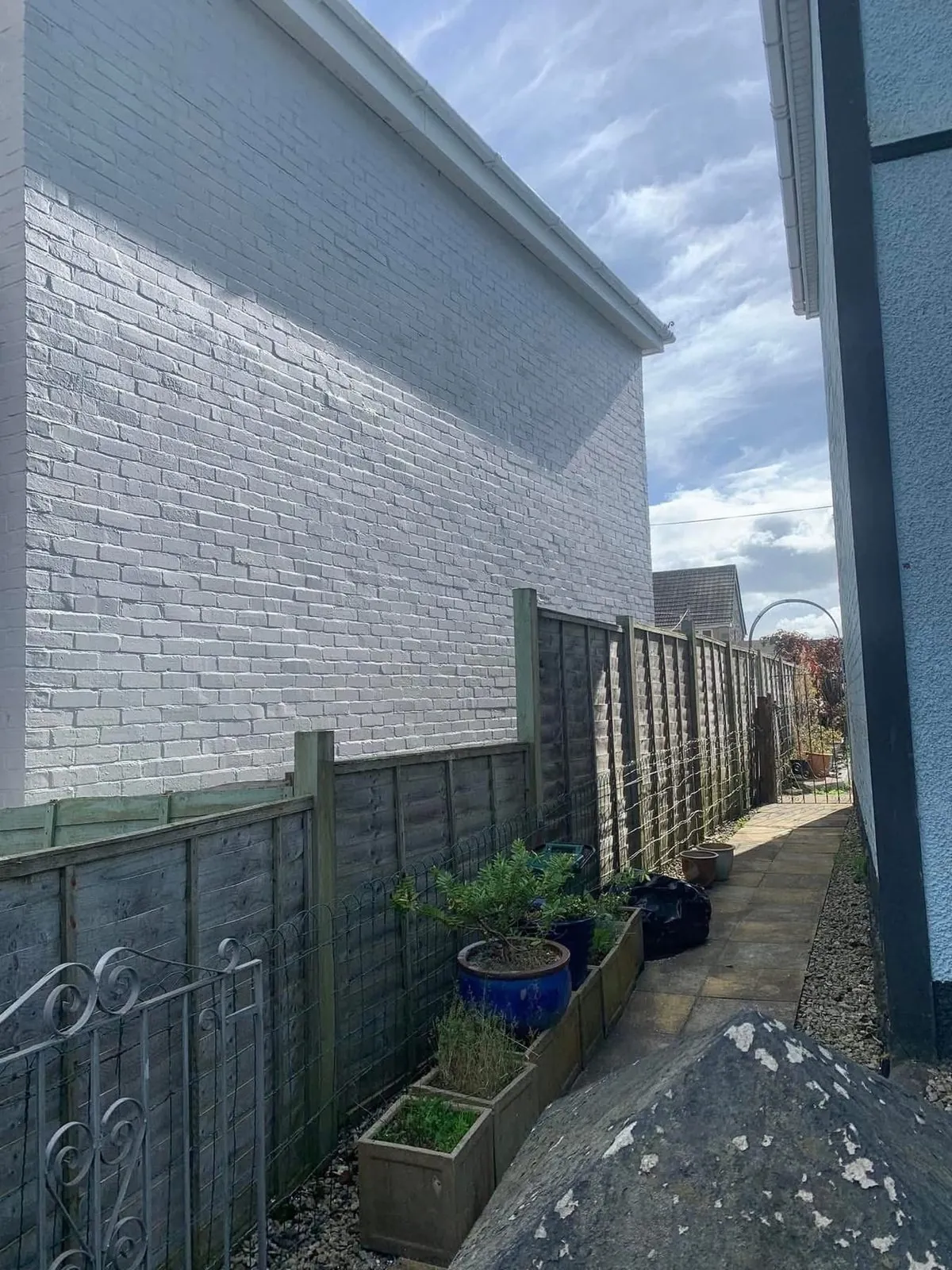 Freshly painted brick wall after preparation and masonry paint in Polperro